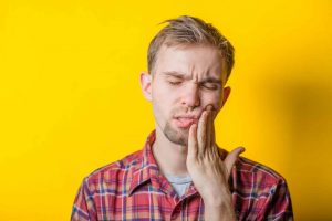Man-struggling-with-oral-pain